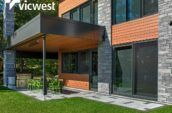 exterior patio of modern home with table surrounded by eight green chairs