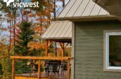 wooden balcony with chairs attached to home in forest during the fall