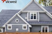 exterior of home with new blue roof and fence in the foreground