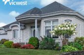 exterior of home with new roof and shrubs in front yard