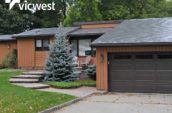 exterior of home with new roof and large pine tree