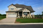 home exterior with large driveway and lawn