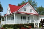 exterior of home with new red metal roof