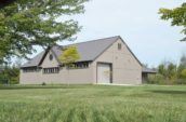 exterior of building with new roof surrounded by field of grass