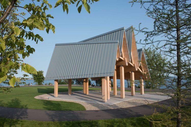 exterior of large gazebo in park with new jaggedly shaped roof