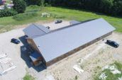 aerial exterior of long building with new metal roof