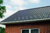 detail of metal roofing on top of brick home