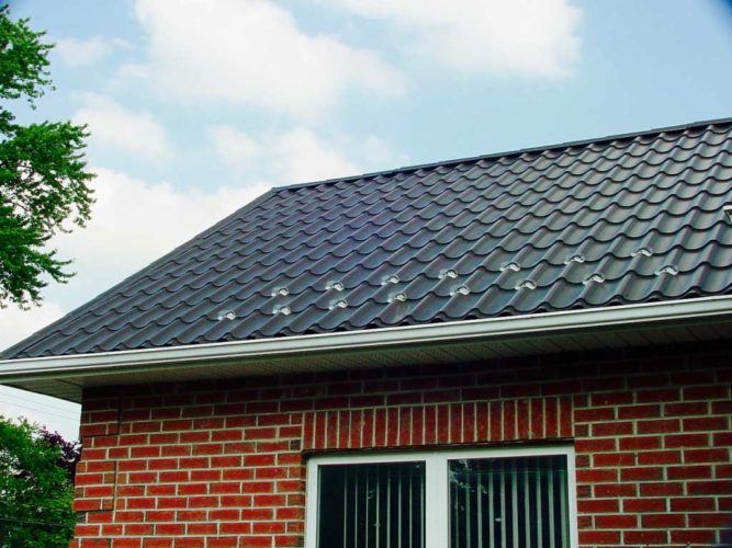 detail of metal roofing on top of brick home